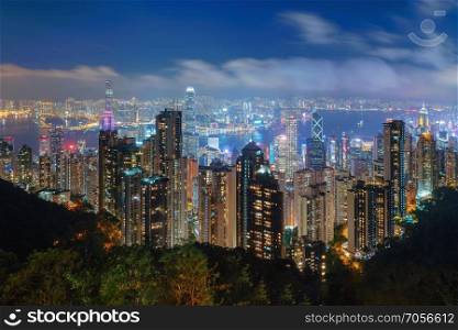 Aerial view of Hong Kong Downtown and Victoria Harbour. Financial district and business centers in smart city, technology concept. skyscraper and high-rise buildings at night.