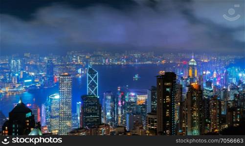 Aerial view of Hong Kong Downtown and Victoria Harbour. Financial district and business centers in smart city, technology concept. skyscraper and high-rise buildings at night.