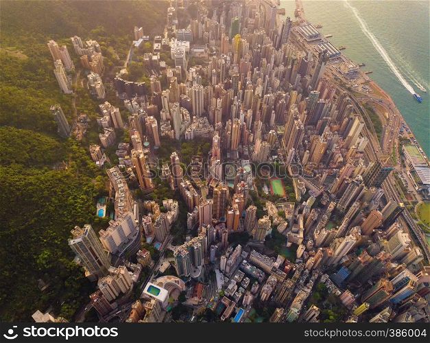 Aerial view of Hong Kong Downtown, China. Financial district and business centers in smart city in Asia. Top view of skyscraper and high-rise buildings at sunset. Top view