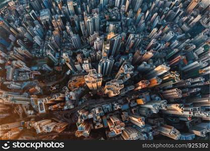 Aerial view of Hong Kong Downtown. Financial district and business centers in smart urban city in Asia. Top view of skyscraper and high-rise buildings at sunset.