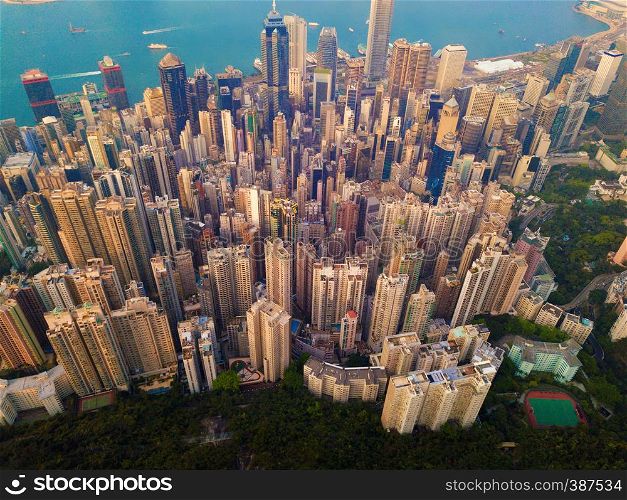 Aerial view of Hong Kong Downtown, Republic of China. Financial district and business centers in smart city in Asia. Top view of skyscraper and high-rise buildings at sunset.