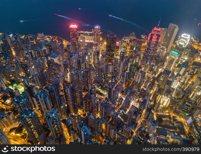 Aerial view of Hong Kong Downtown, Republic of China. Financial district and business centers in smart city in Asia. Top view of skyscraper and high-rise buildings at night.