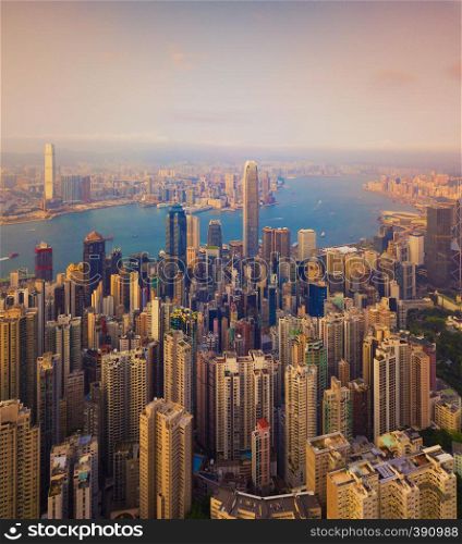 Aerial view of Hong Kong Downtown, Republic of China. Financial district and business centers in smart city in Asia. Top view of skyscraper and high-rise buildings at sunset.