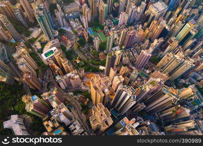 Aerial view of Hong Kong Downtown, Republic of China. Financial district and business centers in smart city in Asia. Top view of skyscraper and high-rise buildings at sunset.