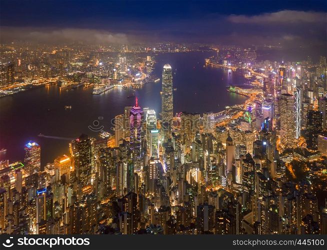 Aerial view of Hong Kong Downtown, Republic of China. Financial district and business centers in smart city in Asia. Top view of skyscraper and high-rise buildings at night.