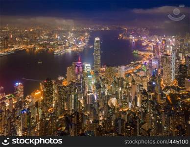Aerial view of Hong Kong Downtown, Republic of China. Financial district and business centers in smart city in Asia. Top view of skyscraper and high-rise buildings at night.