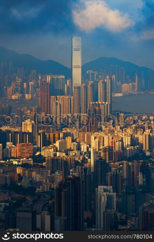 Aerial view of Hong Kong Downtown, Republic of China. Financial district and business centers in technology smart city in Asia. Top view of skyscraper and high-rise buildings at sunset.