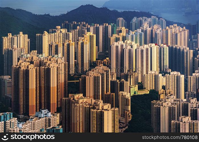 Aerial view of Hong Kong Downtown, Republic of China. Financial district and business centers in technology smart city in Asia. Top view of skyscraper and high-rise buildings at sunset.