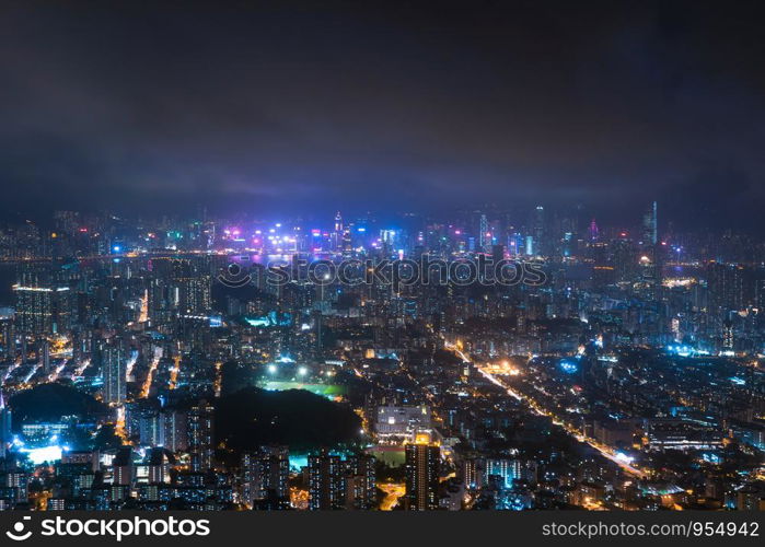 Aerial view of Hong Kong Downtown, Republic of China. Financial district and business centers in technology smart city in Asia. Top view of skyscraper and high-rise buildings at night.