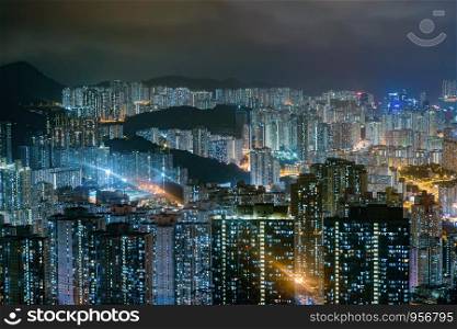 Aerial view of Hong Kong Downtown, Republic of China. Financial district and business centers in technology smart city in Asia. Top view of skyscraper and high-rise buildings at night.