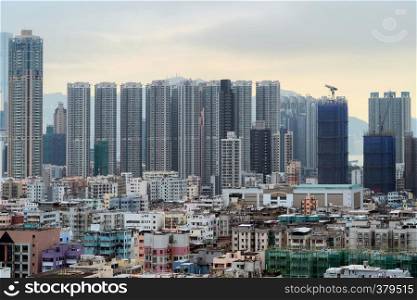Aerial view of intersection in Sham Shui Po, Shek Kip Mei, Hong Kong Downtown. Financial district and business centers in smart city, technology concept. Top view of buildings with cloudy sky.