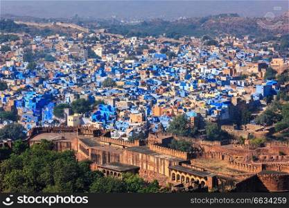 Aerial view of Jodhpur, also known as Blue City due to the vivid blue-painted Brahmin. View from Mehrangarh Fort  part of fortifications is also visible . Jodphur, Rajasthan, India. Aerial view of Jodhpur Blue City. Jodphur, Rajasthan, India