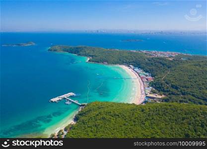 Aerial view of Koh Larn beach, Pattaya with blue turquoise seawater, mountain hills, and tropical green forest trees with Andaman sea in island in summer, Thailand in travel trip. Nature background.