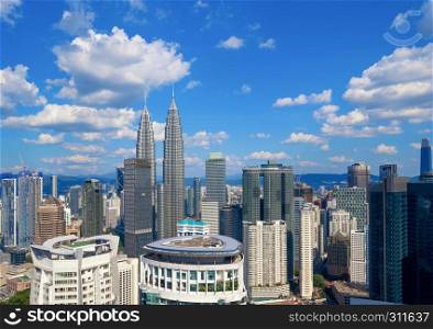 Aerial view of Kuala Lumpur Downtown, Malaysia. Financial district and business centers in smart urban city in Asia. Skyscraper and high-rise buildings at noon with blue sky.