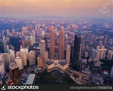 Aerial view of Kuala Lumpur Downtown, Malaysia. Financial district and business centers in smart urban city in Asia. Skyscraper and high-rise buildings at sunset.