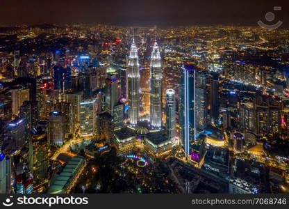 Aerial view of Kuala Lumpur Downtown, Malaysia. Financial district and business centers in smart urban city in Asia. Skyscraper and high-rise buildings at night.