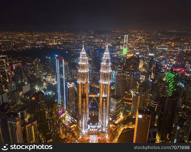 Aerial view of Kuala Lumpur Downtown, Malaysia. Financial district and business centers in smart urban city in Asia. Skyscraper and high-rise buildings at night.