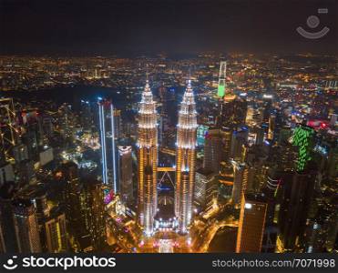 Aerial view of Kuala Lumpur Downtown, Malaysia. Financial district and business centers in smart urban city in Asia. Skyscraper and high-rise buildings at night.