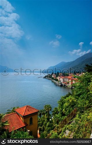 Aerial view of Lake Maggiore with homes on shoreline, Italy.