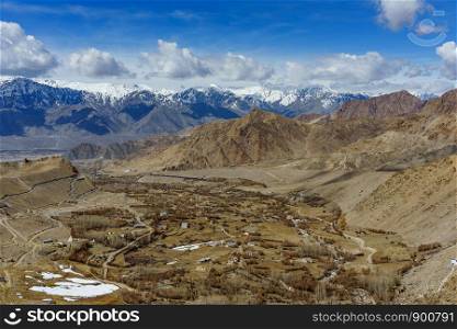 Aerial view of Leh Ladakh City of Kashmir in India with background of Himalaya mountain against blue sky