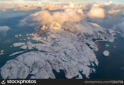Aerial view of Lofoten islands, Nordland county, Norway, Europe. White snowy mountain hills and trees, nature landscape background in winter season. Famous tourist attraction
