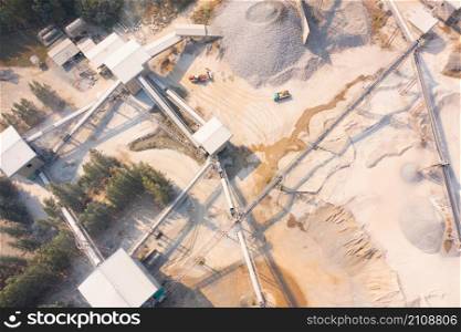 Aerial view of machine excavator trucks dig coal mining or ore with black grunge stone on ground in quarry with mountain hills. Nature landscape background in factory industry. Environment resources