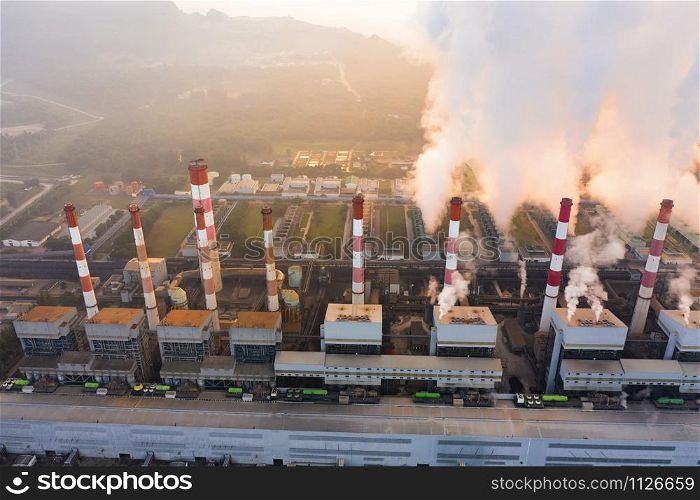 Aerial view of Mae Moh Coal Power Plant with smoke and toxic air from chimney. Factory industry. Electricity tower in energy or pollution environment concept. Lampang City, Thailand