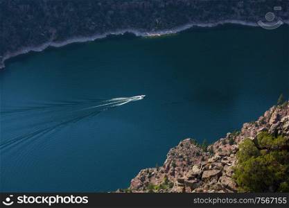 Aerial view of man wakeboarding on lake. Water skiing on lake behind a boat.
