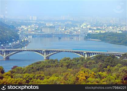 Aerial view of Metro bridge, Pedestrian bridge and Podil district on the background. Kiev, Ukraine