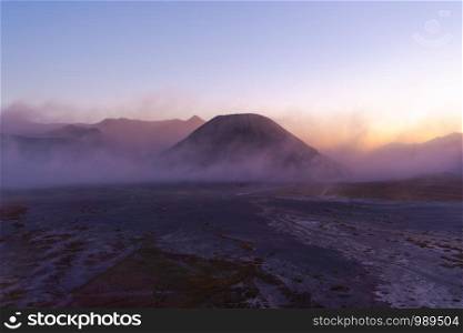 Aerial view of Mount Bromo at sunrise. An active volcano, one of the most visited tourist attractions in east Java from viewpoint, Indonesia. Natural landscape background.