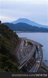 Aerial view of Mountain Fuji with express way, roads at sunset in Shizuoka. Fuji five lakes, Japan. Landscape with hills.