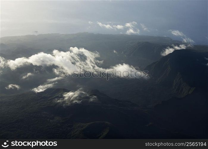Aerial view of mountain landscape with clouds in Maui, Hawaii.