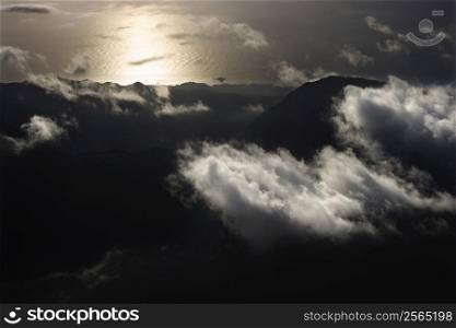Aerial view of mountains with clouds by Pacific ocean on Maui, Hawaii.