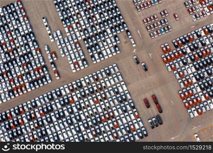 Aerial view of new cars at parking port in automobile factory.