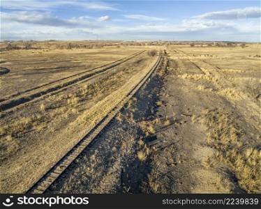 aerial view of northern Colorado landscape in fall or winter scenery - abandoned railroad line and open range with cattle