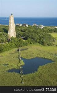 Aerial view of Old Baldy lighthouse in marshy lowlands of Bald Head Island, North Carolina.