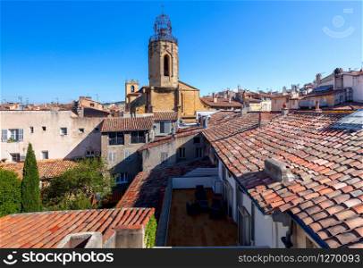 Aerial view of old tiled roofs and the tower of the monastery. France. Aix-en-Provence.. Aix-en-Provence. View of the tiled roofs of the old city on a sunny day.