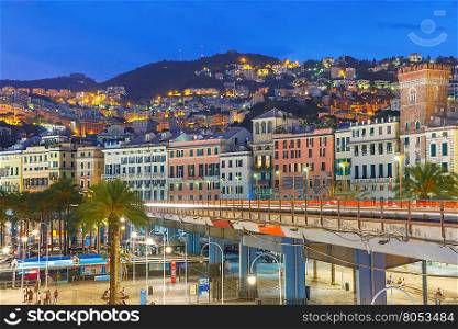 Aerial view of old town, highway and boulevard at night, Genoa, Italy.