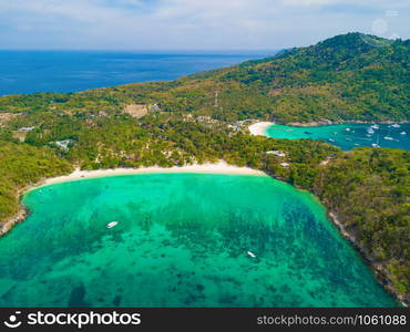 Aerial view of Patong beach with blue turquoise seawater, mountain hills, and tropical green forest trees with Andaman sea in Phuket island in summer, Thailand in travel trip. Nature background.