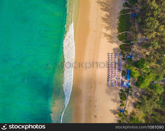 Aerial view of Patong beach with blue turquoise seawater, mountain hills, and tropical green forest trees with Andaman sea in Phuket island in summer, Thailand in travel trip. Nature background.