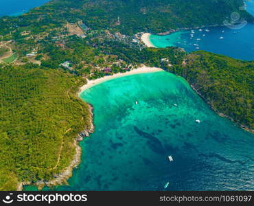 Aerial view of Patong beach with blue turquoise seawater, mountain hills, and tropical green forest trees with Andaman sea in Phuket island in summer, Thailand in travel trip. Nature background.