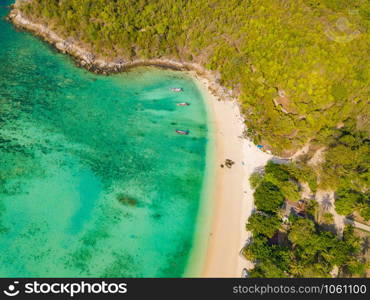 Aerial view of Patong beach with blue turquoise seawater, mountain hills, and tropical green forest trees with Andaman sea in Phuket island in summer, Thailand in travel trip. Nature background.