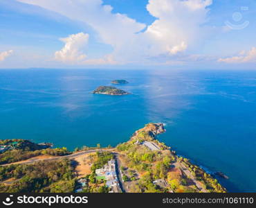 Aerial view of Patong beach with blue turquoise seawater, mountain hills, and tropical green forest trees with Andaman sea in Phuket island in summer, Thailand in travel trip. Nature background.