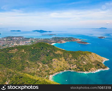 Aerial view of Patong beach with blue turquoise seawater, mountain hills, and tropical green forest trees with Andaman sea in Phuket island in summer, Thailand in travel trip. Nature background.