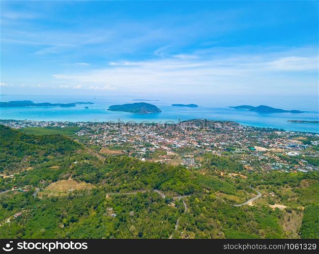 Aerial view of Patong beach with blue turquoise seawater, mountain hills, and tropical green forest trees with Andaman sea in Phuket island in summer, Thailand in travel trip. Nature background.