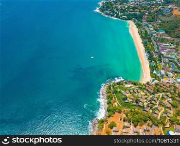 Aerial view of Patong beach with blue turquoise seawater, mountain hills, and tropical green forest trees with Andaman sea in Phuket island in summer, Thailand in travel trip. Nature background.