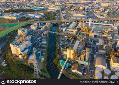 Aerial view of petrochemical oil refinery and sea in industrial engineering concept in Shizuoka district, urban city, Japan. Oil and gas tanks pipelines in industry. Modern metal factory.