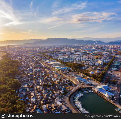 Aerial view of petrochemical oil refinery and sea in industrial engineering concept in Shizuoka district, urban city, Japan. Oil and gas tanks pipelines in industry. Modern metal factory.