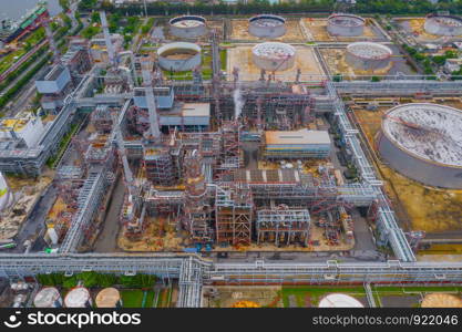 Aerial view of petrochemical oil refinery and sea in industrial engineering concept in Bangna district, Bangkok City, Thailand. Oil and gas tanks pipelines in industry. Modern metal factory.