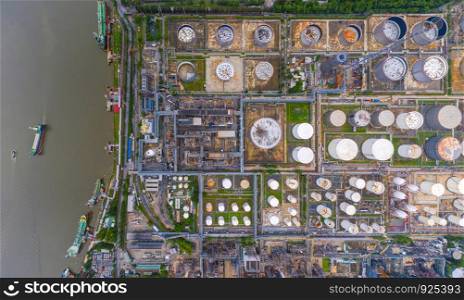 Aerial view of petrochemical oil refinery and sea in industrial engineering concept in Bangna district, Bangkok City, Thailand. Oil and gas tanks pipelines in industry. Modern metal factory.
